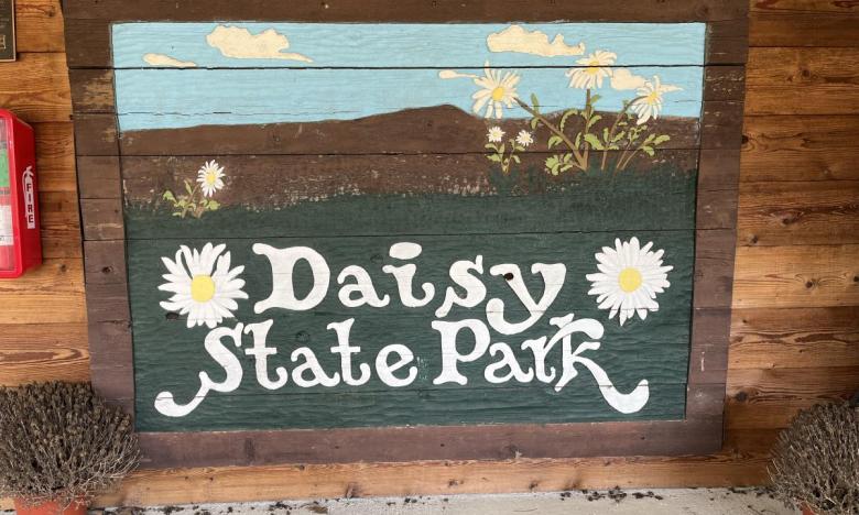 The original wooden Daisy State Park entrance sign.